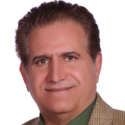 A man with a beard and mustache wearing a jacket.