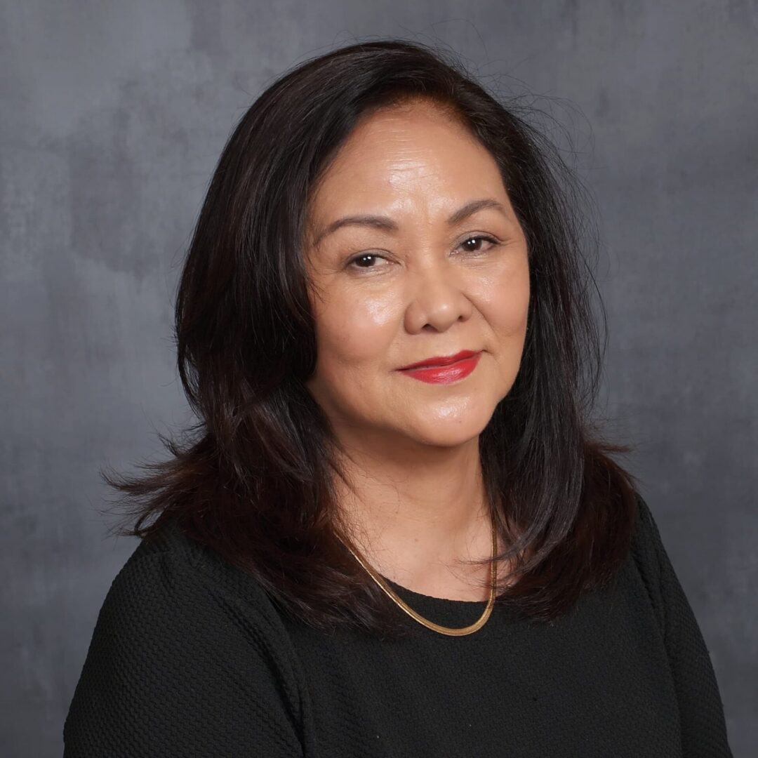 Woman with long hair, wearing black top.